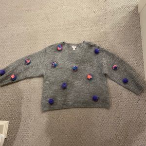 Cat and Jack grey sweater with Pom poms on it
